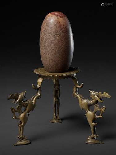 AN INDIAN STONE BRAHMANDA, ‘COSMIC EGG’, AND MATCHING BRONZE TRIPOD STAND