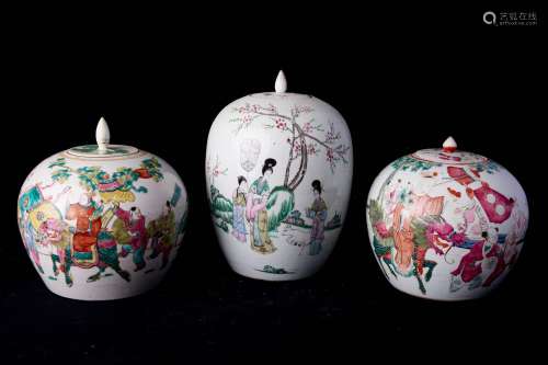 中国，20世纪。一对带有节日和蝙蝠装饰的有盖花瓶。高度：21厘米。壶盖和壶沿上有小划痕，其中一个壶盖缺失。附上一个有盖的花瓶，上面有花园中妇女的装饰。背面有诗。高度：31厘米。盖子内侧有小划痕。白底聚彩珐琅瓷。