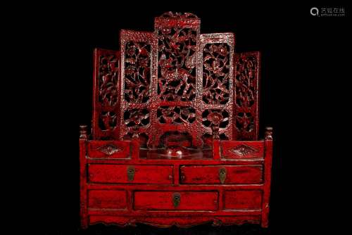 中国，20世纪。红色漆面木制梳妆台，开口处有三个抽屉，背景的镂空装饰代表着自然界中进化的奇美拉。(尺寸待定)