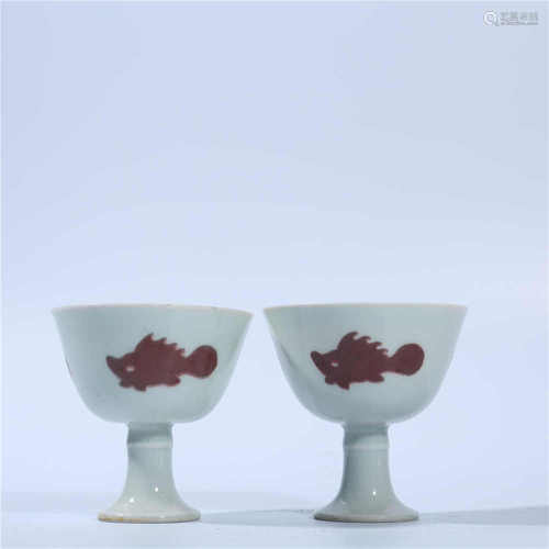 A pair of red three fish pattern high foot cups in Chenghua glaze of Ming Dynasty