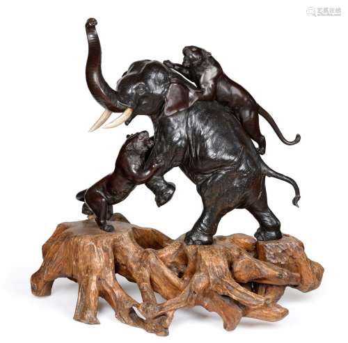 A Japanese Bronze Large Okimono, Meiji period, as an elephant being attacked by two tigers, the