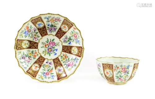 A Worcester Porcelain Tea Bowl and Saucer, the porcelain circa 1770, the decoration later, of fluted