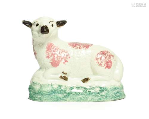 A Pratt Type Figure of a Sheep, circa 1800, recumbent with puce sponged markings on a green washed