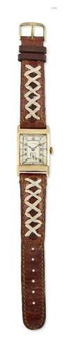 A 9ct. gold wristwatch by Vertex, the two tone rectangular dial with applied Arabic gilt numerals,