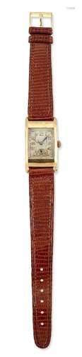 A 9ct. gold wristwatch by Vertex, the rectangular dial with luminous Arabic numerals, blued steel