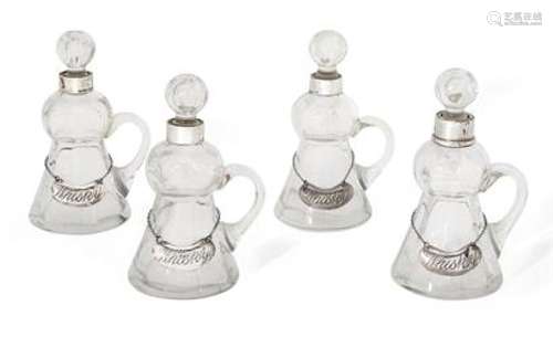 A matched set of four silver mounted glass whisky noggins, three London, c.1912, Stuart Clifford &