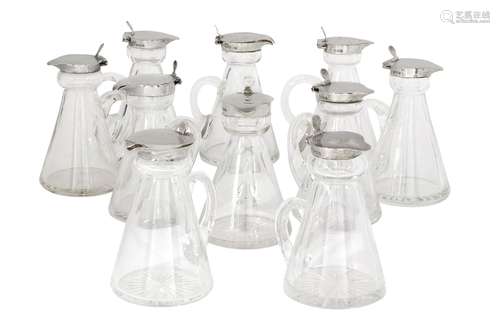 A large collection of silver mounted whisky tots, comprising thirty glass tots with silver collars