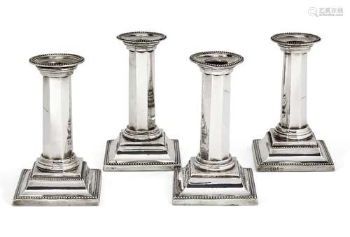 A matched set of four Victorian silver candlesticks, Sheffield, c.1887 and 1896, James Deakin &