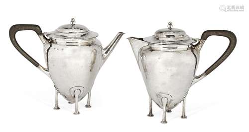 A hammered silver teapot and hot water jug, Birmingham, c.1911. Robinson & Co., each raised on