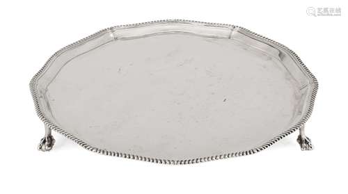 A shaped silver salver with gadroon rim, Sheffield, c.1946, Roberts & Belk, raised on three claw and