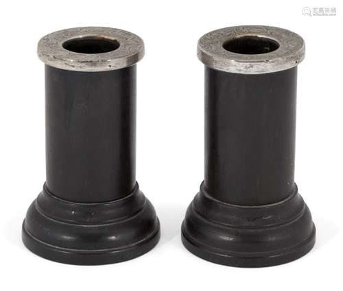 A pair of dwarf ebony candlesticks with silver mounted sconces, London, c.1914, H F Daltrey & Co.,