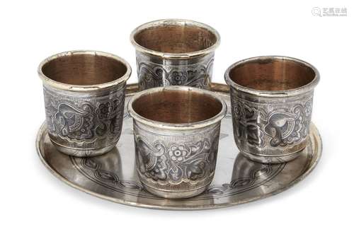 A Russian silver niello coaster with four Russian silver niello beakers, all post 1958, stamped