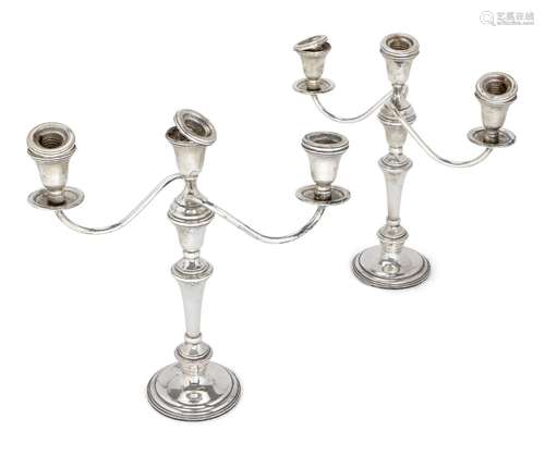 A pair of three-branch candelabra candlesticks, bases stamped 'weighted sterling', each