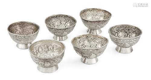 A set of six white metal salts, unmarked, assumed Indian silver, of circular form, each richly