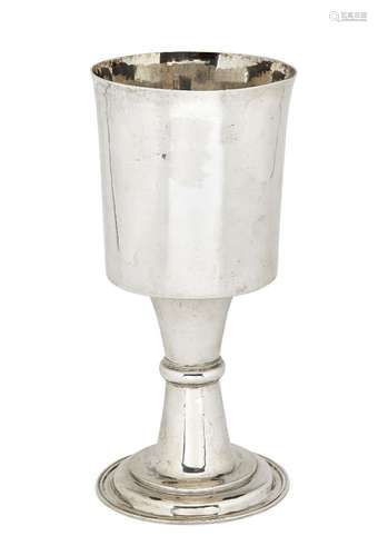 A large white metal goblet, unmarked, the plain cylindrical cup to waisted stem raised on stepped