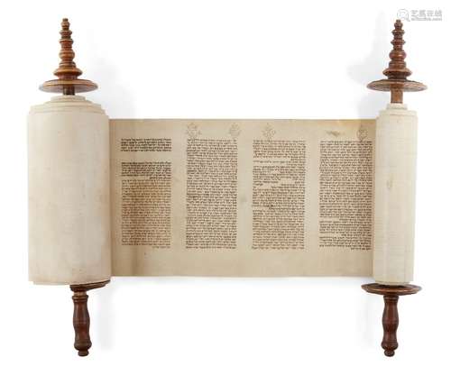 A miniature Sefer Torah Scroll mounted on carved wooden rollers, the text written on vellum in a