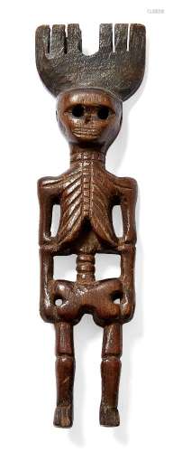 A Guatamalan carved wood slingshot, 19th century, carved as a skeleton, 19cm highPlease refer to