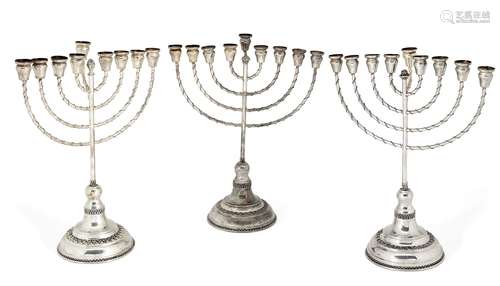 A pair of silver menorahs, by Hazorfim, stamped 925, each raised on a stepped circular foot