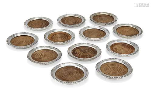 A set of twelve Continental silver coasters with turned wooden bases, all stamped sterling, each