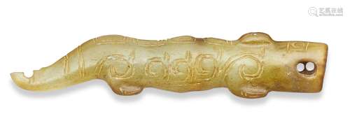 A Chinese green jade archaistic pendant, 17th century, carved as a crocodile engraved with archaic