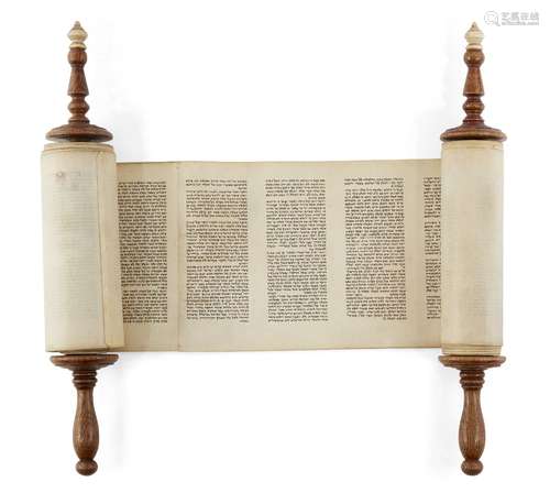 A miniature Sefer Torah mounted on ivory capped wooden rollers, probably 18th century, Germany or