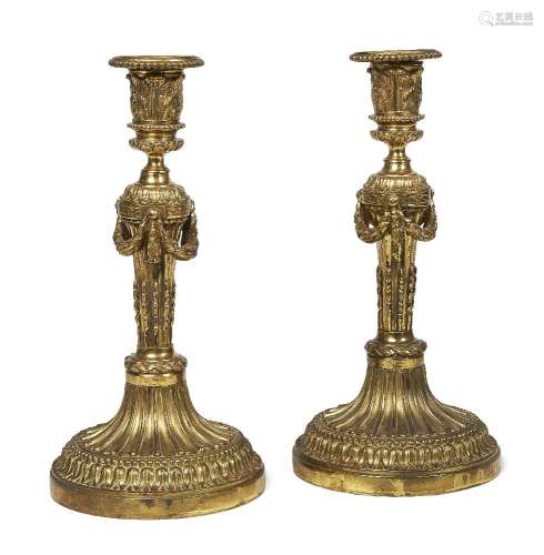 A pair of French ormolu candlesticks, c.1820, each with acanthus cast socket above tapering fluted