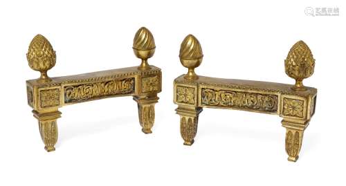 A pair of Louis XVI ormolu chenets, late 18th century, each with scrolling foliate frieze mount