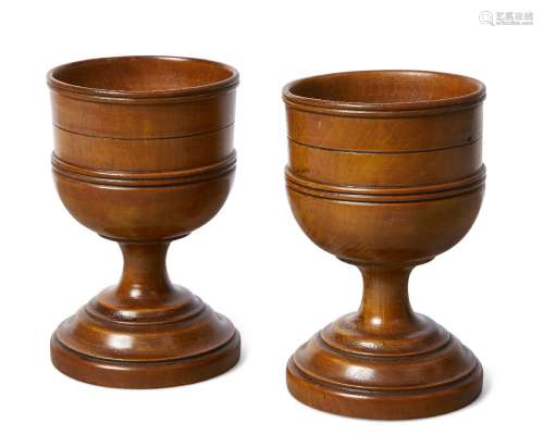 A pair of English turned treen goblets, c.1800, each with moulded and incised bowl above a spreading