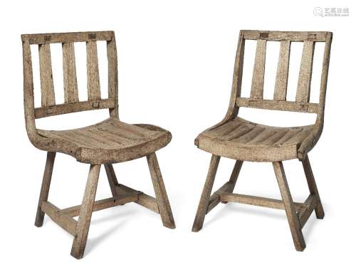 A pair of naïve teak side chairs, 19th/20th century, with vertical spar backs and dished slatted