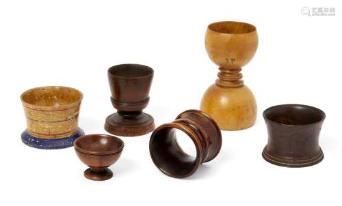A group of treen items, 19th century, comprising: a lignum vitae dice shaker, a salt in the form