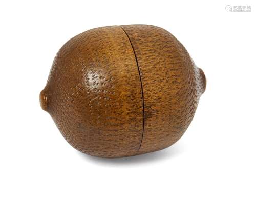 A treen box modelled as a lemon, late 19th century, 7cm long, together with a boxwood needle case,
