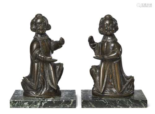 A pair of North German bronze models of kneeling angels, early 17th century, each depicted with hand