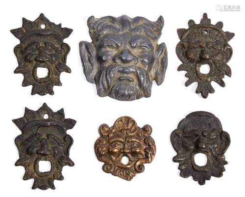 A group of five bronze escutcheons modelled as grotesque masks, 17th-19th century, including a pair,