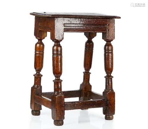 A 17th century oak joint stool on turned supports united by perimeter stretcher,