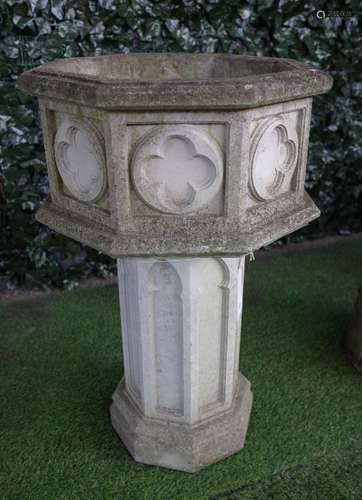 A reconstituted stone Gothic revival octagonal planter/font with relief quatrefoil panels,