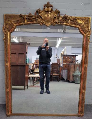 A 19th century French overmantel mirror, with cartouche crest over leaf moulded frame,