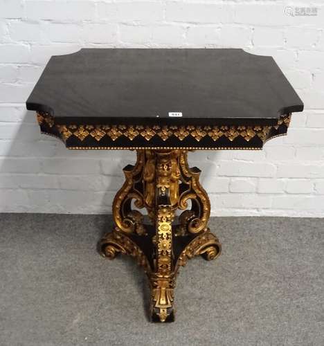 A Victorian parcel gilt ebonised centre table with re-entered cornered rectangular top on a trio of