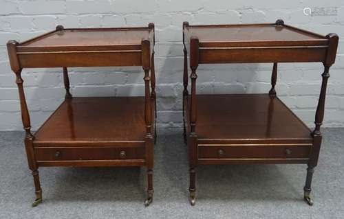 A pair of mahogany square two tier occasional tables with single drawer bases on turned supports,