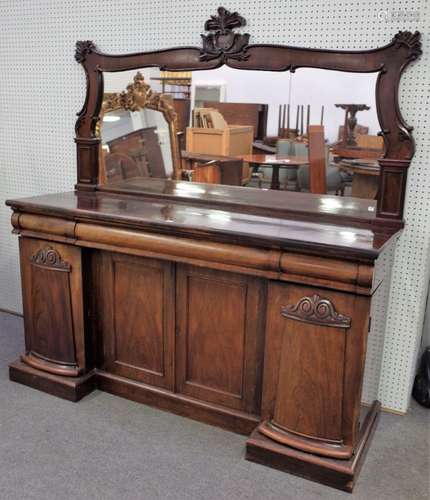 An early Victorian rosewood sideboard, with a foliate and scroll carved mirror back,