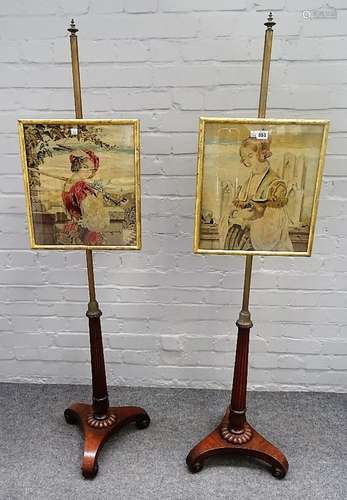 A pair of Regency mahogany, parcel gilt pole screens, with reeded columns and inswept trefoil bases,