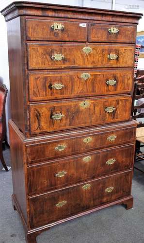 A George II featherbanded figured walnut chest on chest,