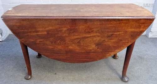 A George II mahogany oval drop flap table on pad feet, 137cm wide x 73cm high.