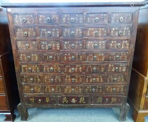 A Chinese hardwood apothecary chest with seven rows of five short drawers,