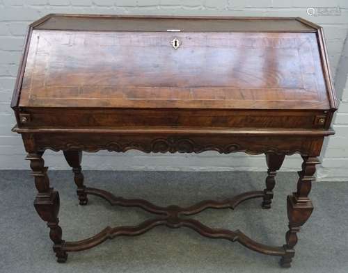 A 17th century Italian walnut bureau, with fitted interior, on square baluster supports,