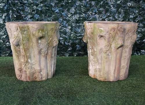 A pair of terracotta jardinieres naturally cast as ivy clad tree trunks, 46cm wide x 49cm high.