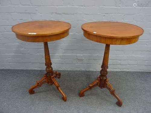 A pair of North European walnut circular occasional tables, on tripod bases,