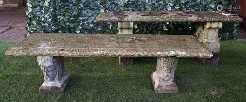 A reconstituted stone rectangular garden bench on scroll trestle end standards,