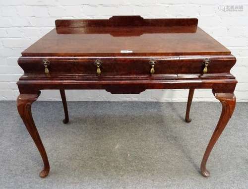 A George II style figured walnut side table, with three cushion frieze drawers,