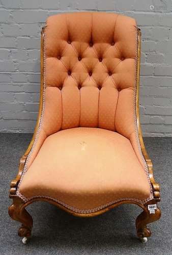 A Victorian walnut slipper back nursing chair, with serpentine seat on scroll supports,