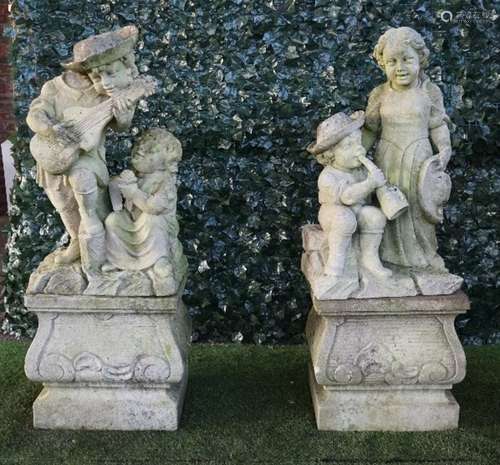 A pair of Vincenza stone figure groups of child musicians on square baluster stands,